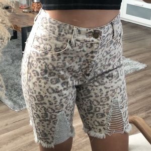 Distressed cheetah print denim shorts